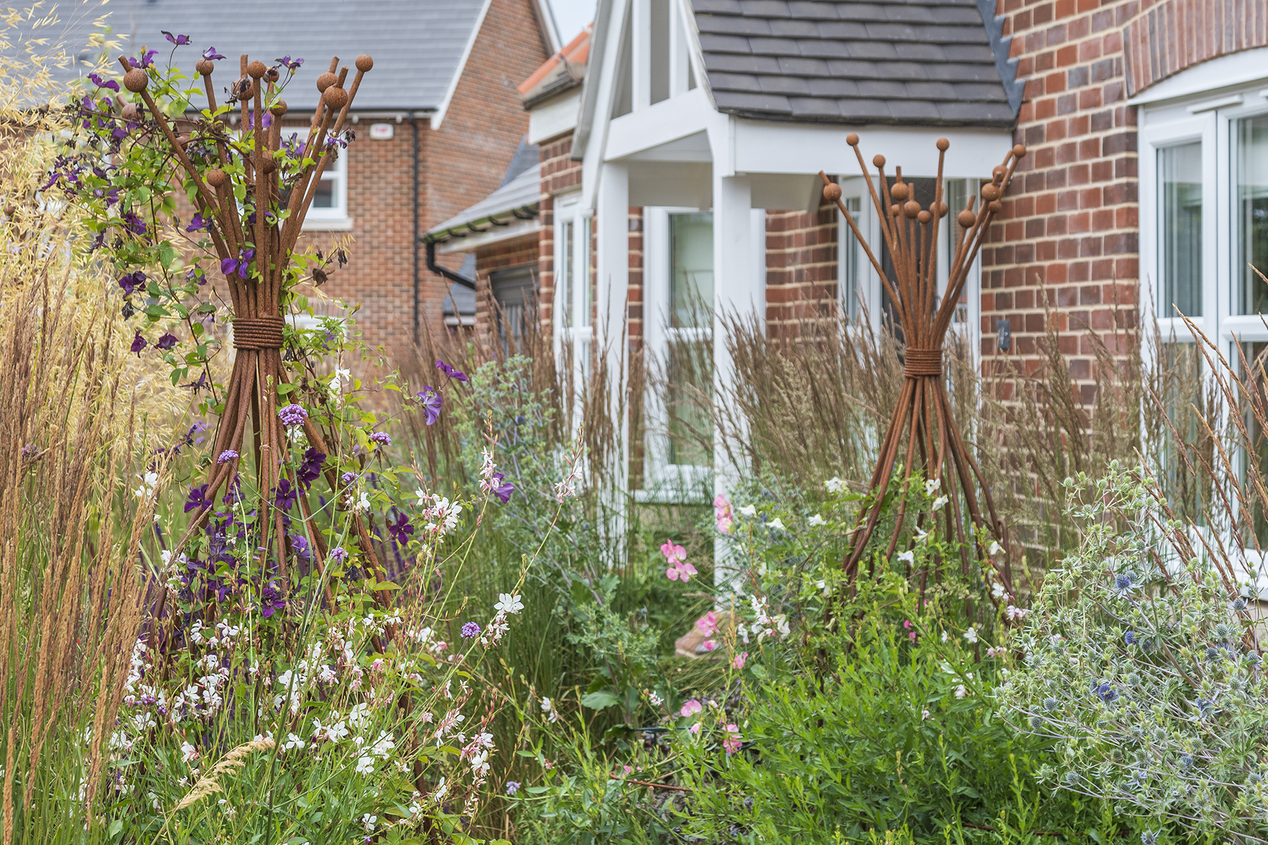 Traditional Garden Bradfield Essex. Design and Build Cube 1994. Front Garden Obelisks